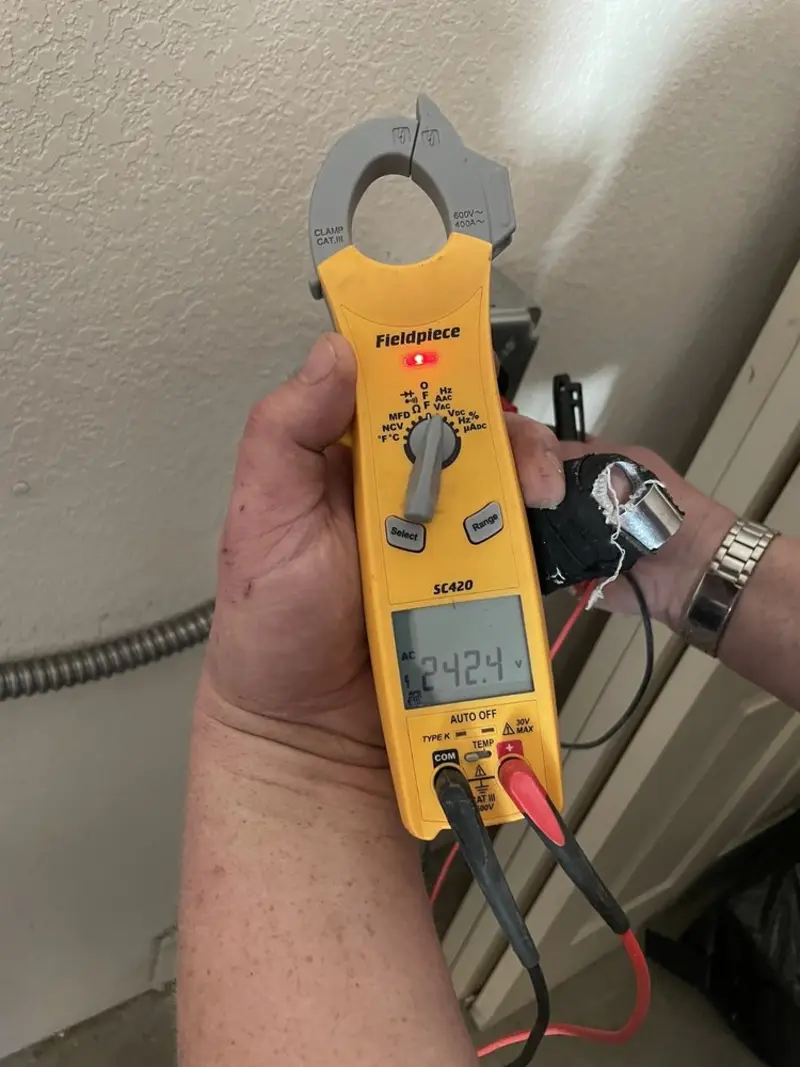 Voltage testing with clamp meter during Outlet Installation in Medina